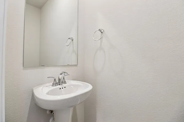 a bathroom with a sink a mirror and a shower