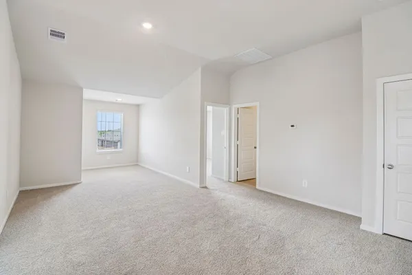 a view of an empty room and a window