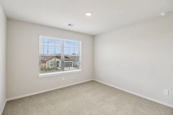 a bedroom with bed and a window
