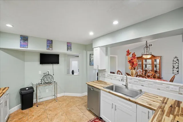 a spacious bedroom with a bed and a double vanity sink