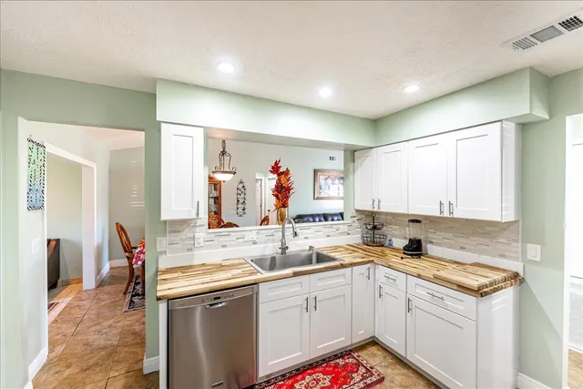 a kitchen with stainless steel appliances granite countertop a sink and cabinets