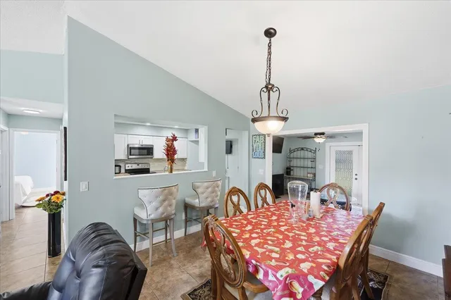 a view of a dining room with furniture a chandelier and wooden floor