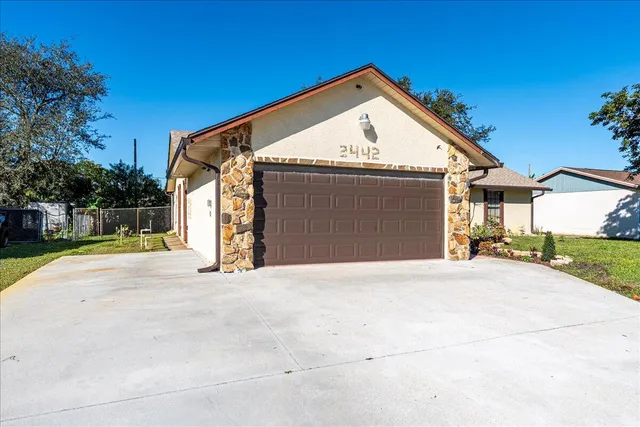 a view of a house with a yard and garage