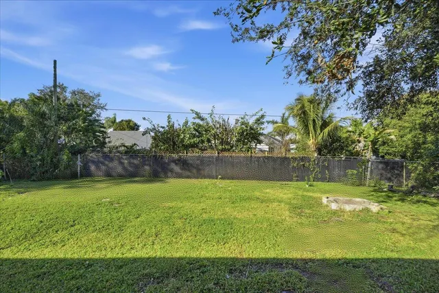 a view of a swimming pool with a yard