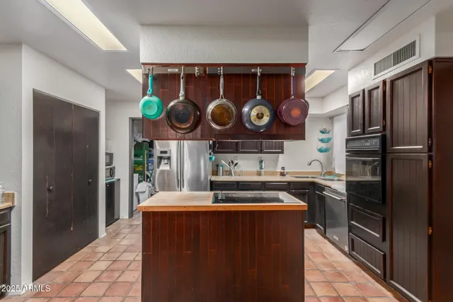 a kitchen with stainless steel appliances granite countertop a refrigerator and stove
