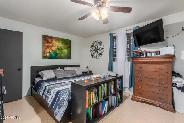 a bedroom with furniture and a flat screen tv