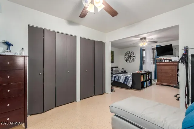 a bedroom with a bed and a television