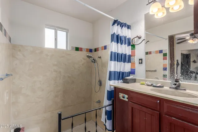 a bathroom with a sink a mirror and shower