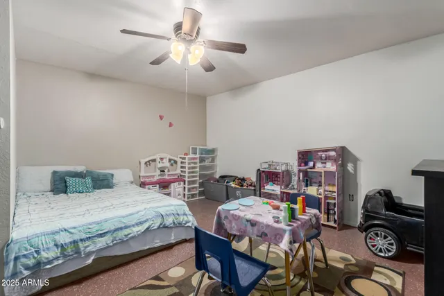 a bedroom that has a bed and a chandelier