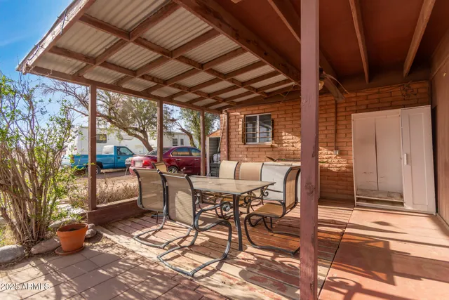 a view of a patio with table and chairs and potted plants