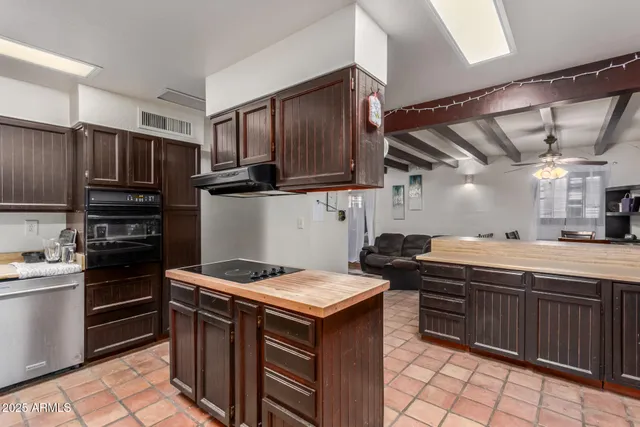 a kitchen with a stove sink and cabinets