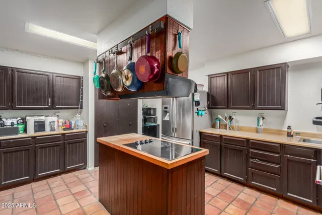 a kitchen with stainless steel appliances granite countertop a sink and a stove