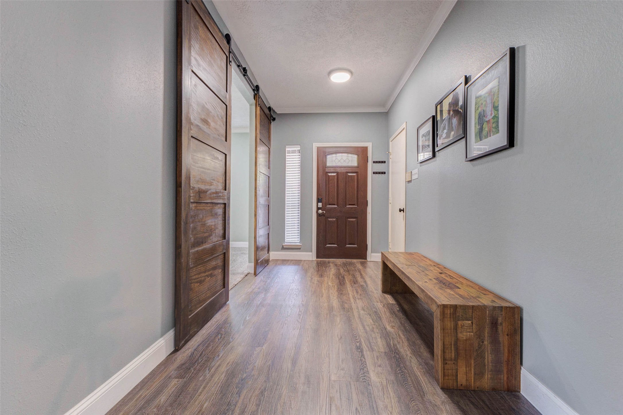 9215 Landry Boulevard Spring, TX 77379 - Photo 5 of 42 Custom sliding barn doors open to a versatile flex space that can easily serve as a home office, playroom, formal living area, or additional entertaining space.