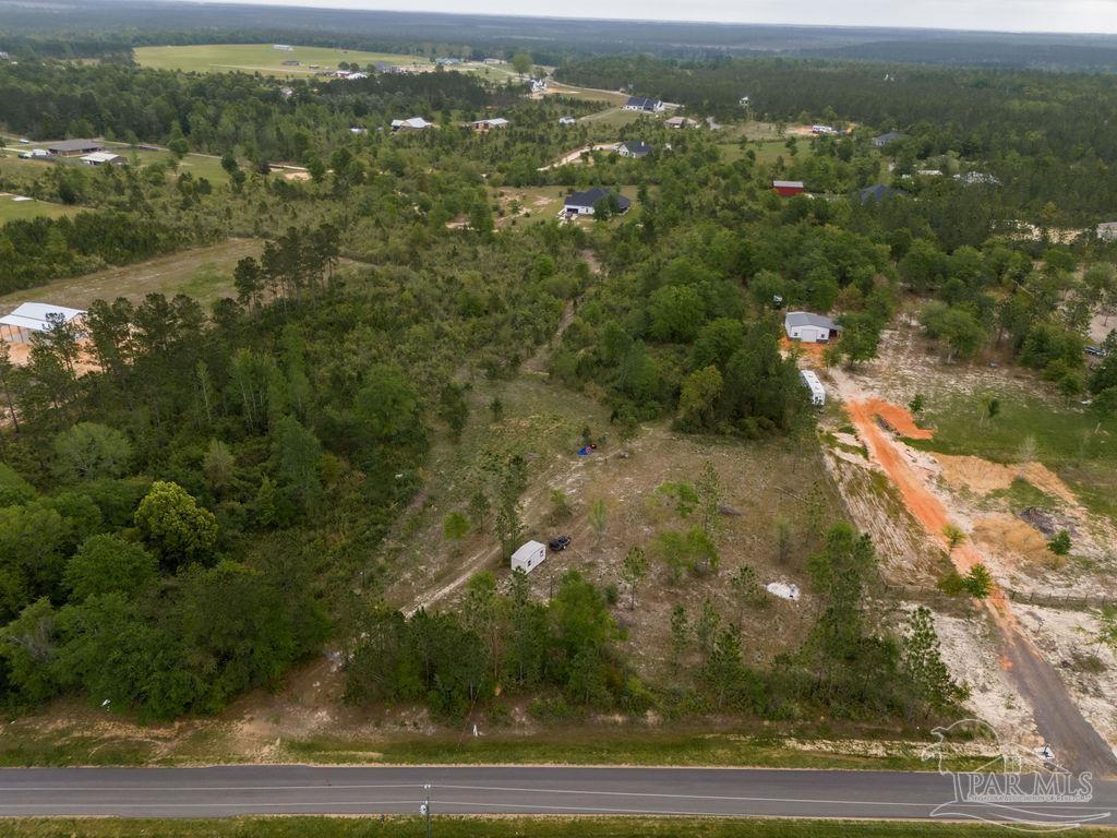 7706 Tidwell Road Pace, FL 32571 - Photo 17 of 25 an aerial view of residential houses with outdoor space and trees