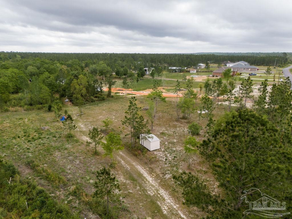 7706 Tidwell Road Pace, FL 32571 - Photo 19 of 25 a view of a lake with lots of residential buildings
