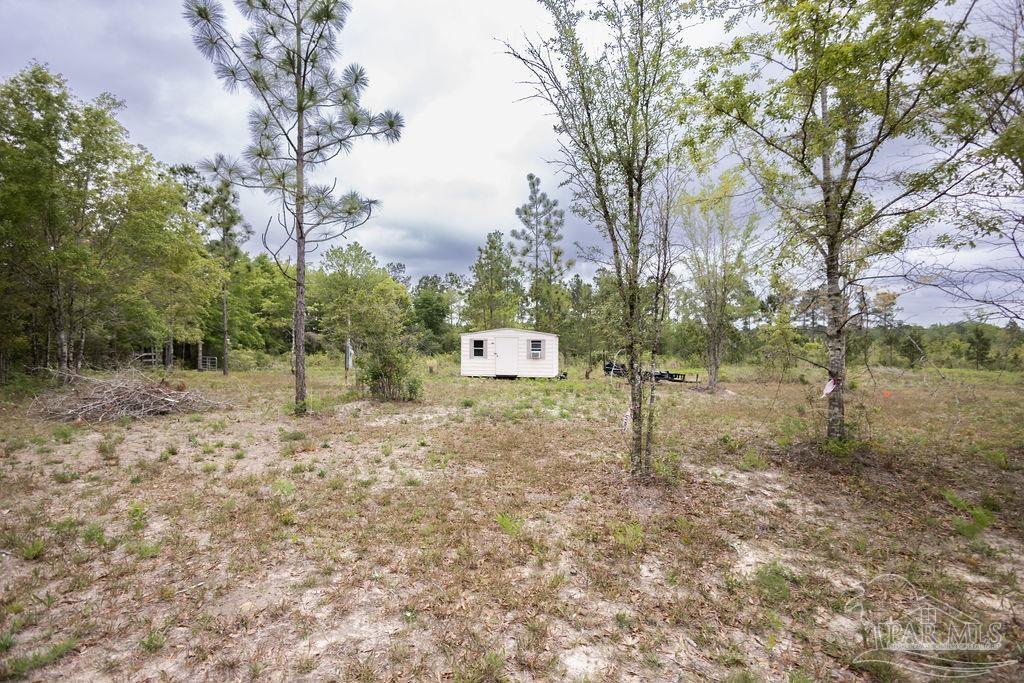 7706 Tidwell Road Pace, FL 32571 - Photo 9 of 25 a house view with a backyard space