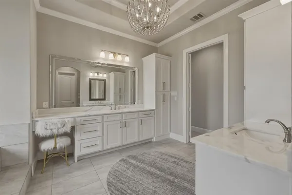 a spacious bathroom with a granite countertop sink a mirror and a bathtub