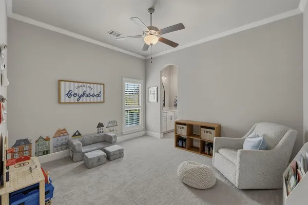 a living room with furniture and a ceiling fan