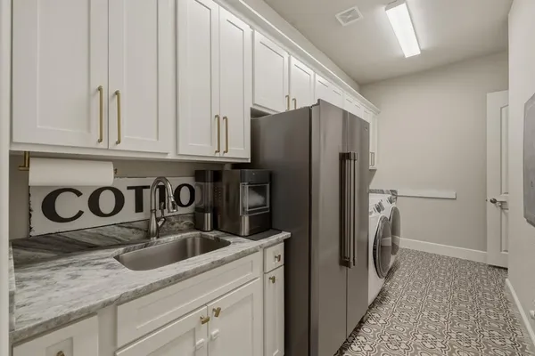 a kitchen with stainless steel appliances granite countertop a refrigerator and a sink