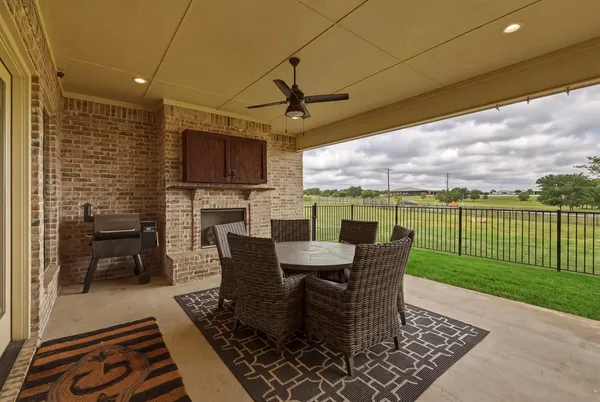 a view of a porch with furniture and a yard