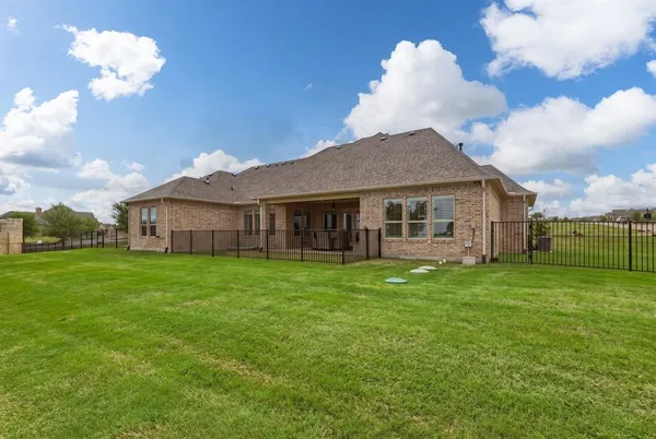 a view of a house with a big yard and a garden