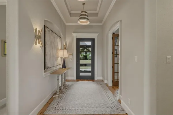 a view of a hallway with wooden floor and staircase