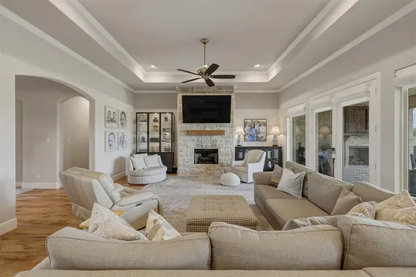 a living room with furniture a fireplace and a flat screen tv