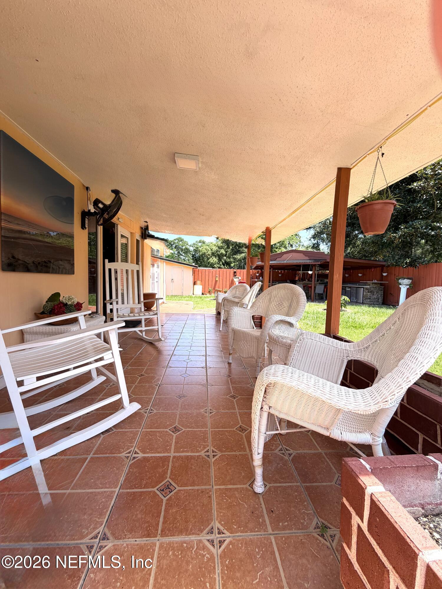 4127 Springwood Road Jacksonville, FL 32207 - Photo 39 of 63 a view of a patio with a table and chairs