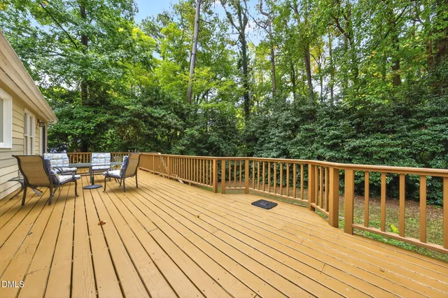 a balcony with wooden floor and outdoor space