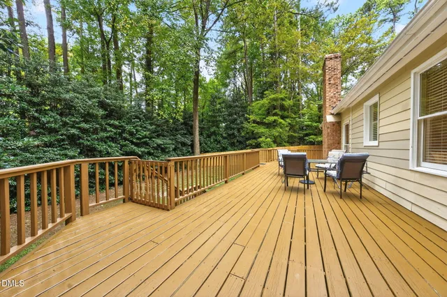 a view of balcony with wooden floor and outdoor seating