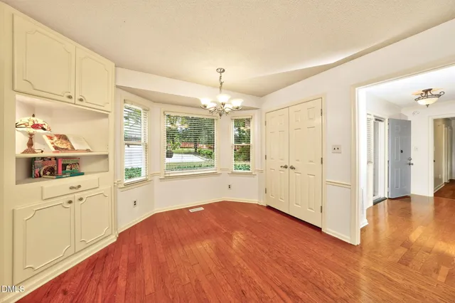 a big room with wooden floor and windows
