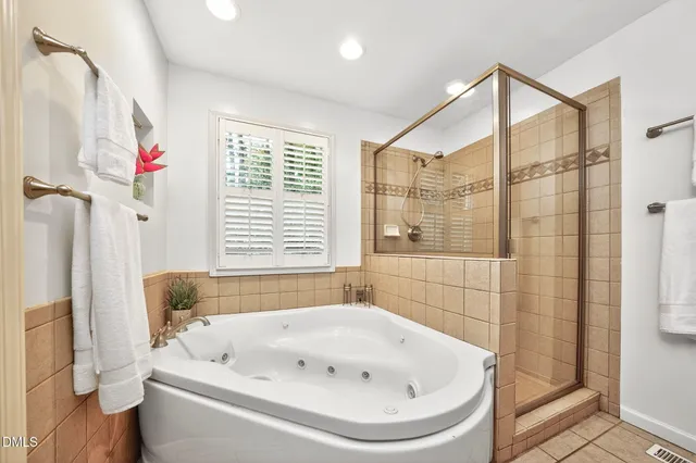 a bathroom with a tub and shower