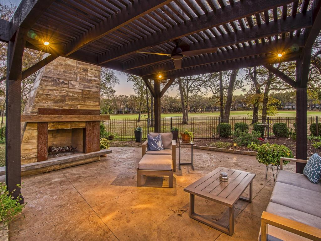 a building outdoor space with patio furniture and a fireplace