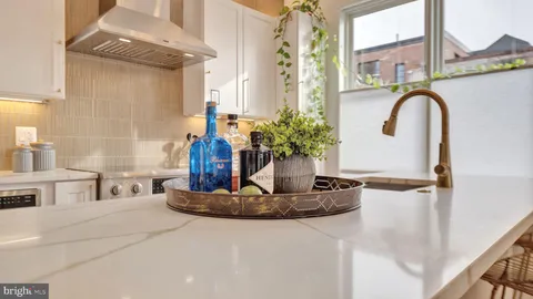 a bathroom with a granite countertop sink a mirror and a shower