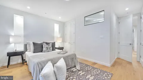 a bedroom with a bed and a lamp on the table
