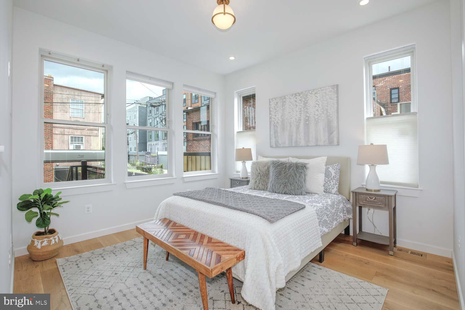 1528 Oates Street Northeast, Unit 1 Washington, DC 20002 - Photo 15 of 54 a bedroom with a bed and a potted plant