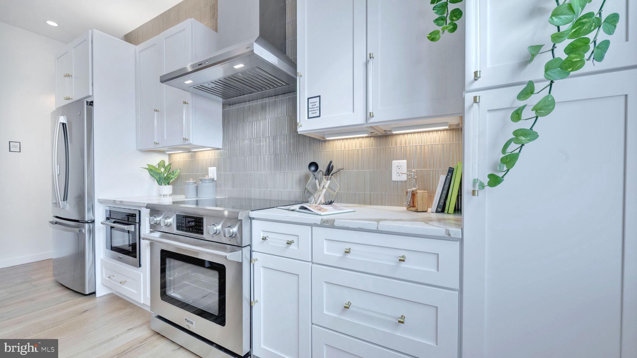 1528 Oates Street Northeast, Unit 1 Washington, DC 20002 - Photo 16 of 54 a kitchen with stainless steel appliances a stove refrigerator and cabinets