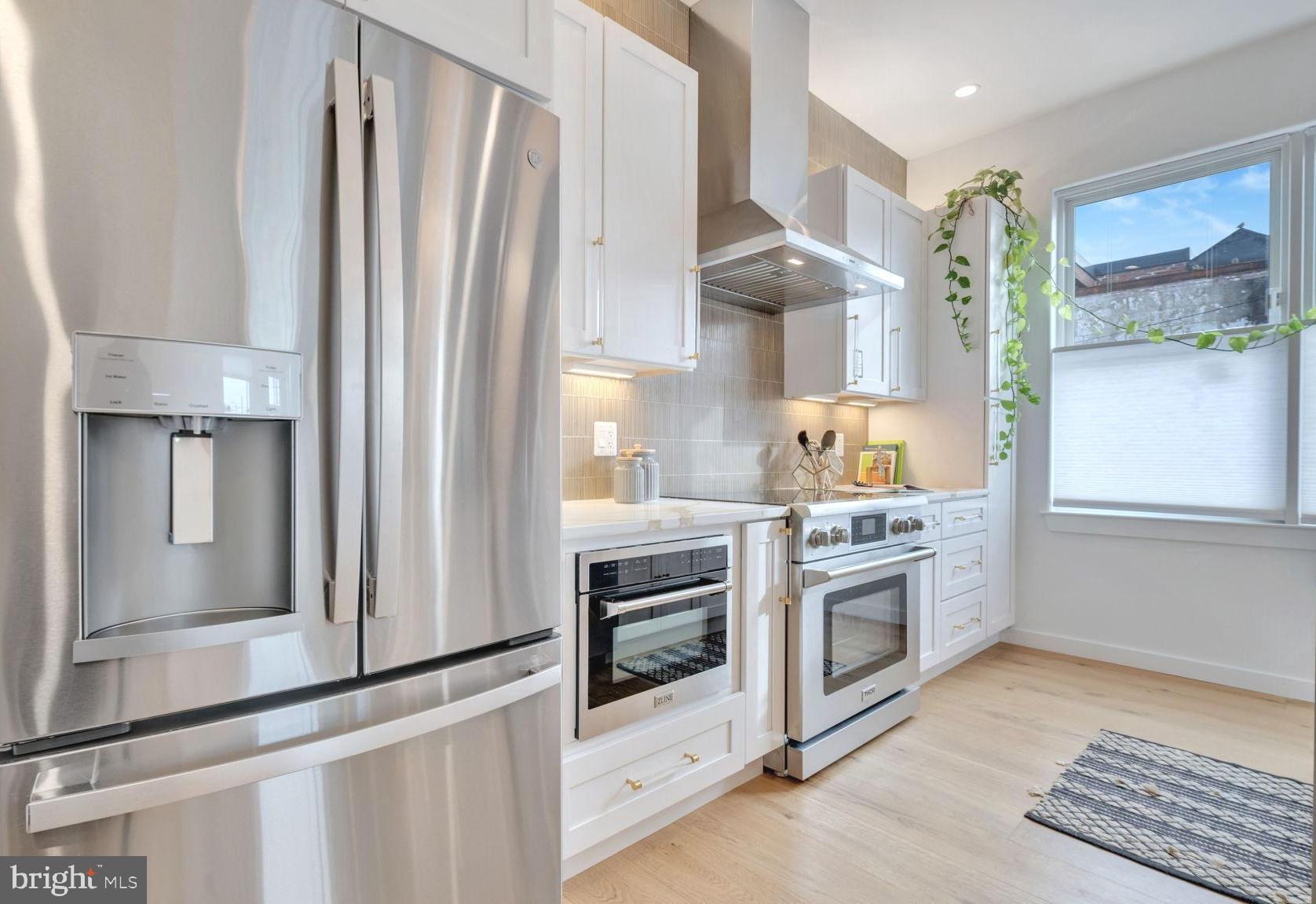1528 Oates Street Northeast, Unit 1 Washington, DC 20002 - Photo 18 of 54 a kitchen with stainless steel appliances a stove and a refrigerator