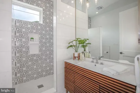 a bathroom with a sink a vanity and a mirror