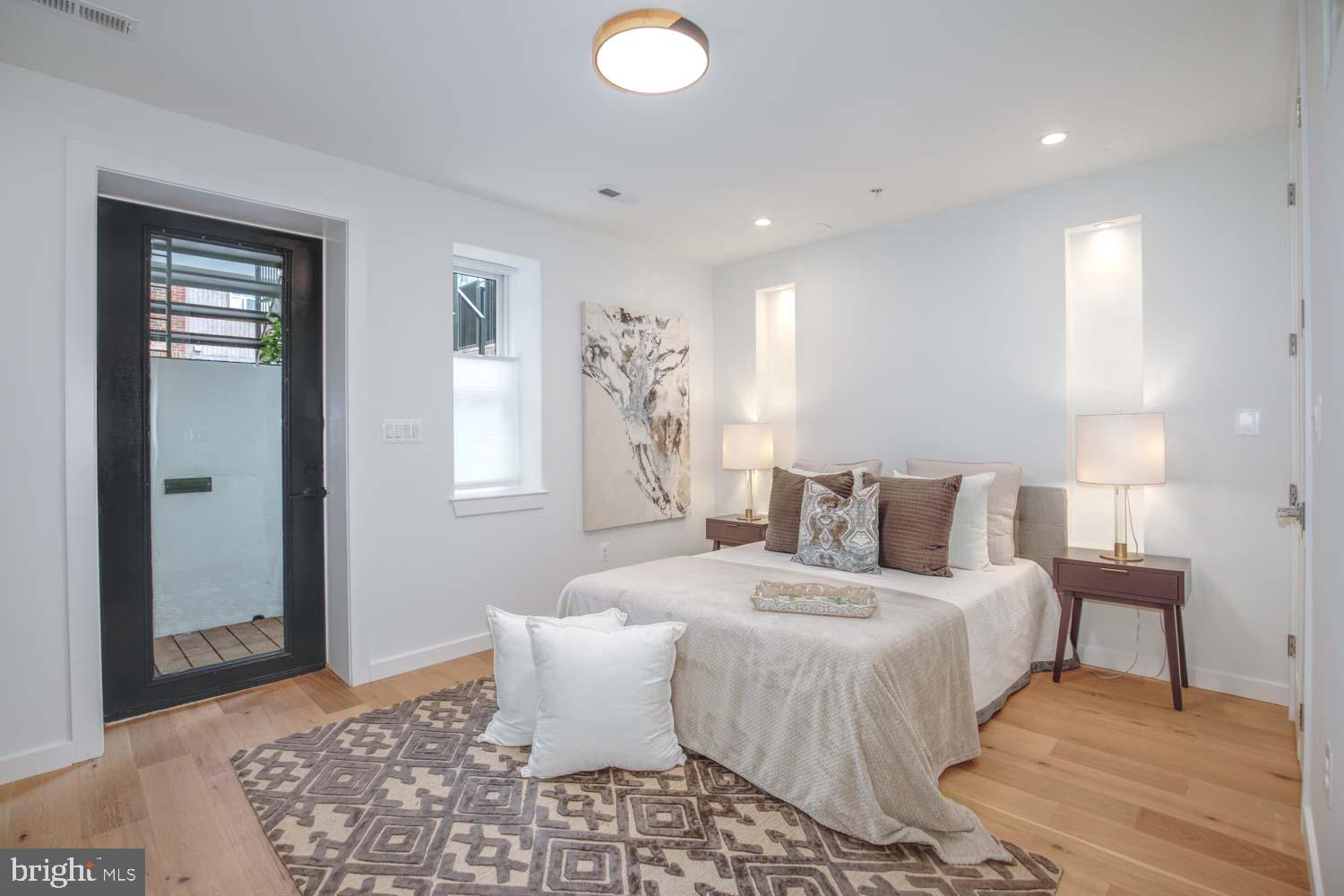 1528 Oates Street Northeast, Unit 1 Washington, DC 20002 - Photo 21 of 54 a bedroom with a large bed and a rug