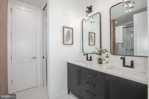 a bathroom with a sink a toilet a shower and a mirror