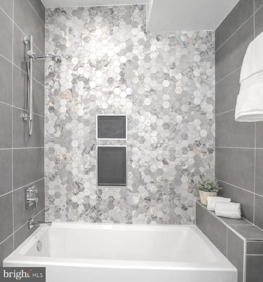 1528 Oates Street Northeast, Unit 1 Washington, DC 20002 - Photo 38 of 54 a bathroom with a bathtub and a shower
