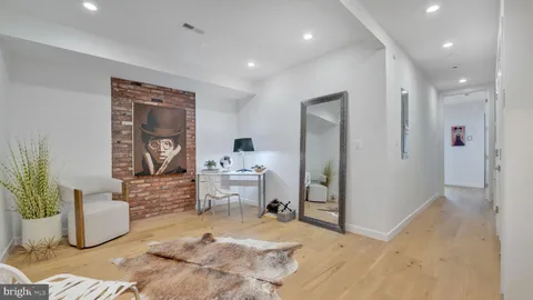 a kitchen with a refrigerator and white cabinets