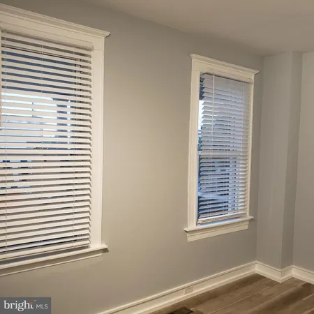 a view of a small space with wooden floor and a window