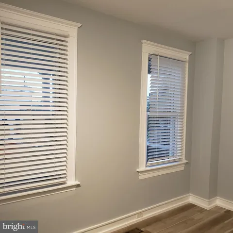 a view of a small space with wooden floor and a window