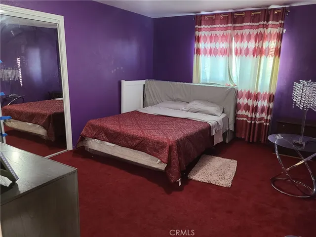 a bedroom with a bed and a table