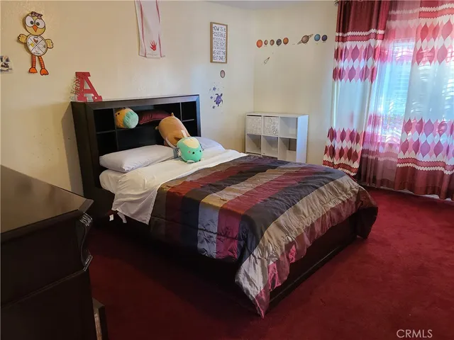 a bedroom with a bed and a table