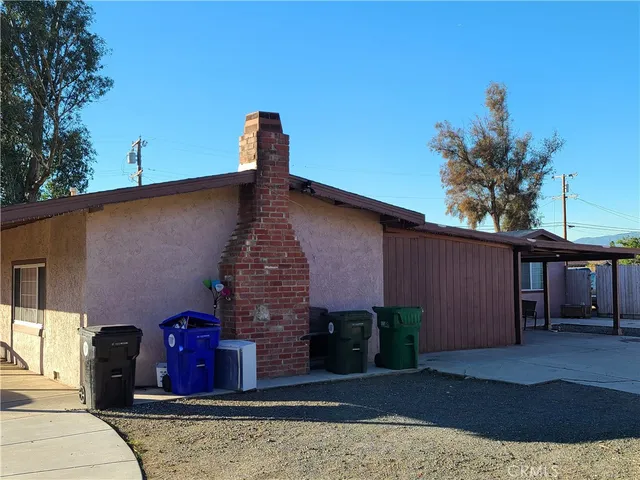 a front view of a house with plants