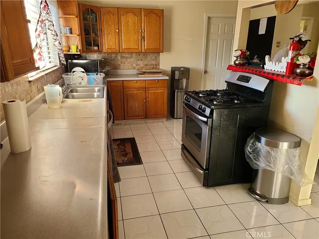a kitchen with a refrigerator and a sink