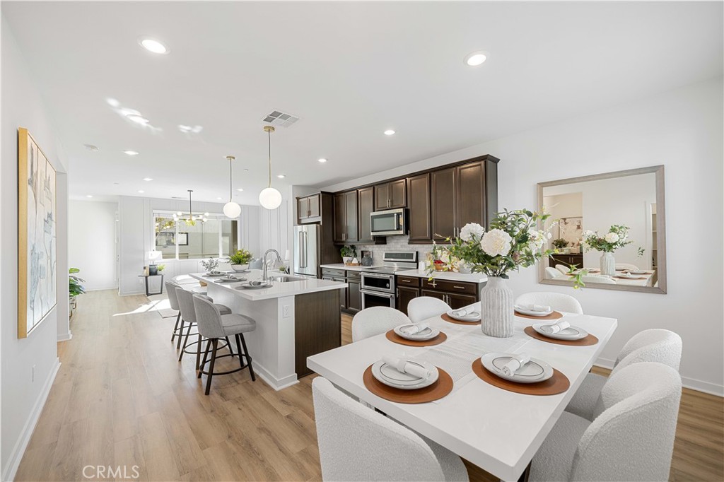 a dining room filled furniture and wooden floor